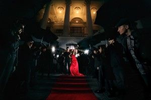 woman in red dress on the red carpet photos of paparazzi